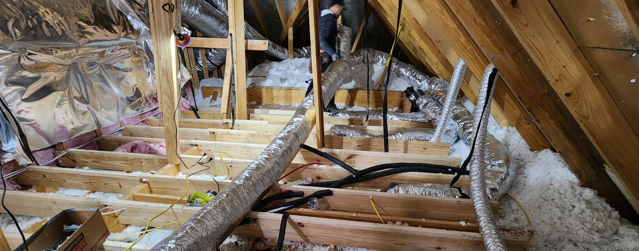 Unfinished attic with exposed joists, insulation and ductwork