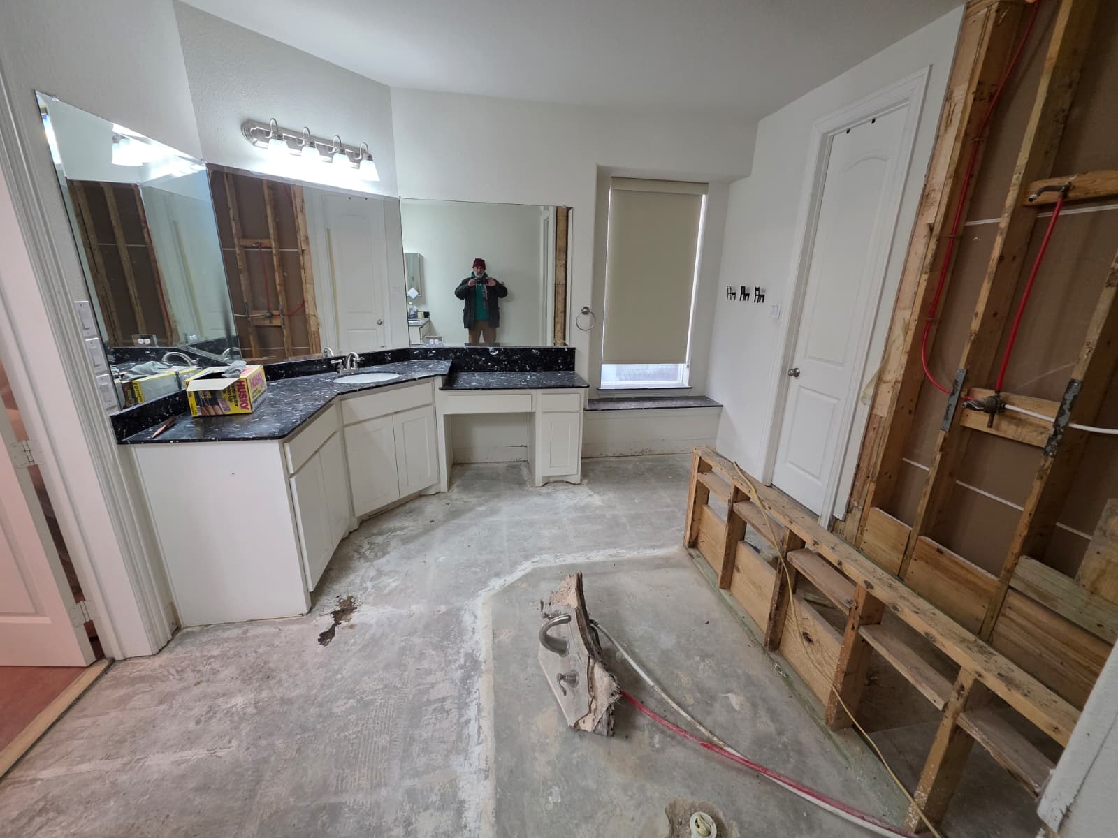 Primary bathroom stripped to the studs and bare slab