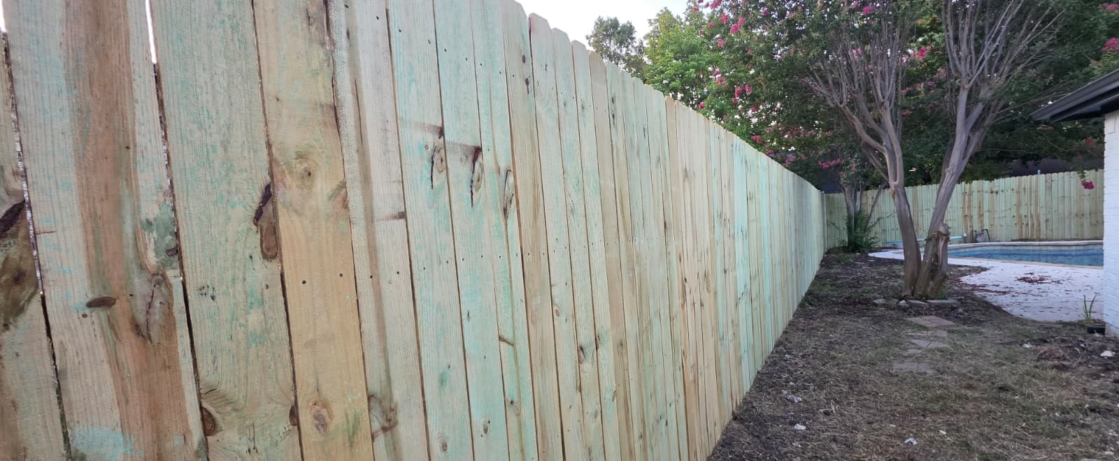 New pine privacy fence replacing a failing one in a Dallas backyard